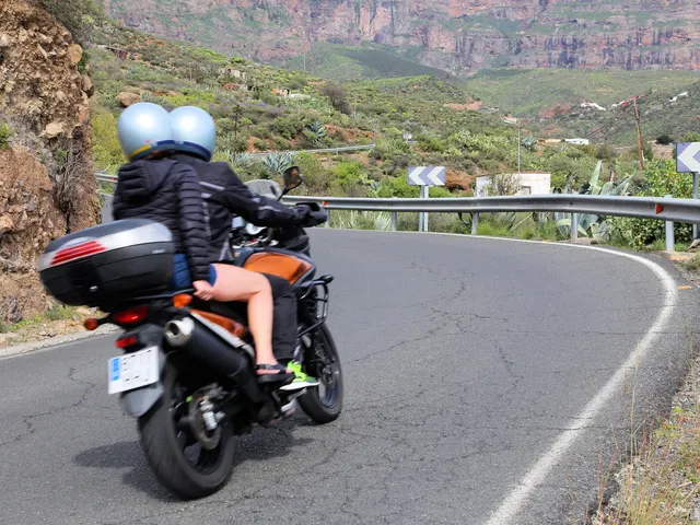 Touring motorcycle riders leaning into curves on Moroccan mountain road