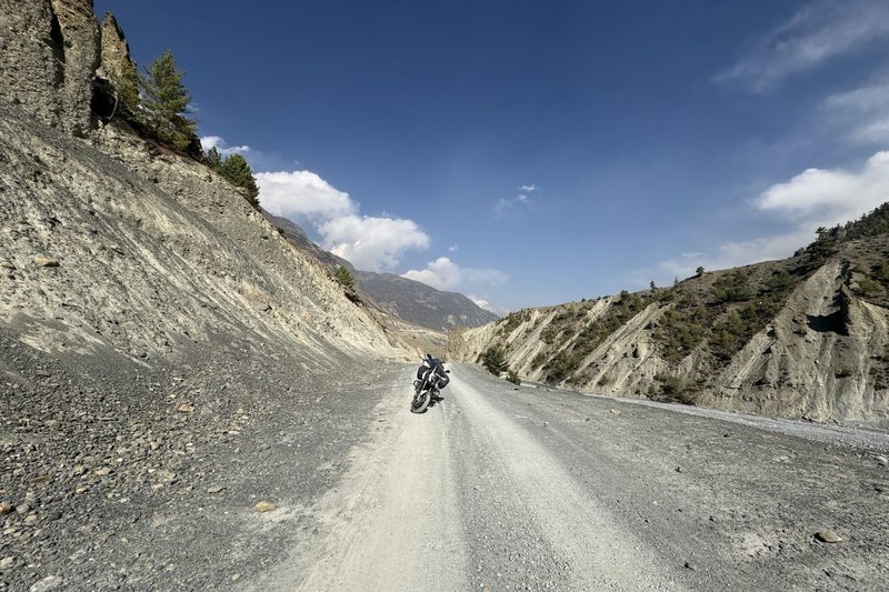 Motorcycle rider crossing high mountain pass in the Moroccan Atlas Mountains